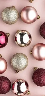 Elegant holiday ornaments on a pink background.