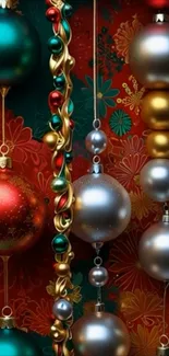 Colorful Christmas ornaments hanging against a festive red background.