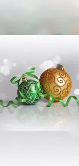 Green and gold festive ornaments with ribbon on a bokeh background.