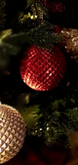 Close-up of festive red and gold ornaments on a Christmas tree.