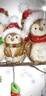 Three cute owls in Santa hats on a festive branch.