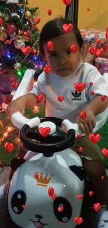 Child on a panda bike with Christmas tree and gifts.