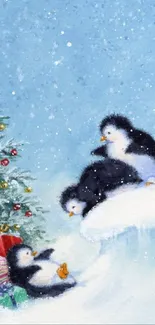 Illustration of playful penguins and Christmas tree with presents in the snow.