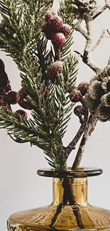 Festive pine and berries in amber vase.