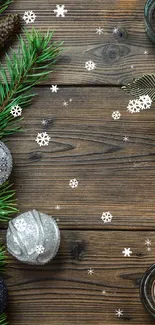 Cozy festive wallpaper with pine, candles, and ornaments on wooden background.