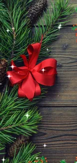 Festive wallpaper with pine cones and a red ribbon on wood.