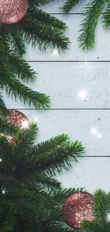 Christmas pine garland with red ornaments on wood background.