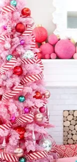 Pink Christmas tree with colorful ornaments and candy cane stripes.