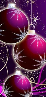 Purple and pink Christmas ornaments on a festive background.