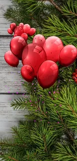 Red balloons in pine branches with festive decor.