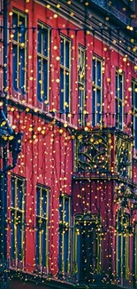 Red building with festive string lights glowing in an urban night scene.