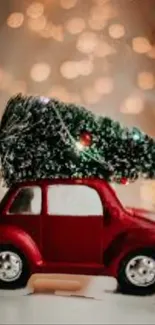 Red toy car with Christmas tree on a festive bokeh background.