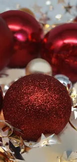 Vibrant red Christmas ornaments with glittered surfaces for a festive look.