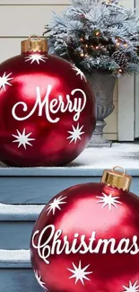 Festive red Christmas ornaments on snowy steps with decorations.