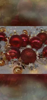 Vibrant red Christmas ornaments on snow with golden accents.