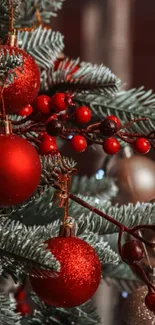 Festive Christmas tree with red ornaments and pine branches.