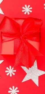 Festive red gift box with silver stars on red background.