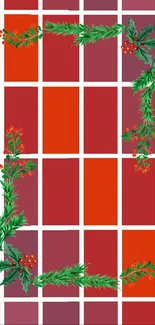 Red grid wallpaper with festive green foliage and berries.