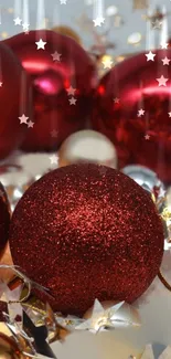 Red holiday ornaments with shimmering stars.