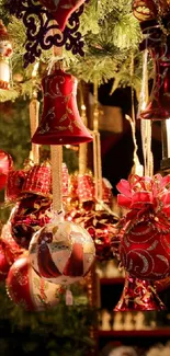 Festive red Christmas ornaments hanging on a tree.