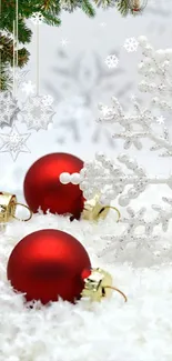 Red Christmas ornaments and snowflake on snowy background.