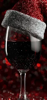Festive red wine glass with Santa hat wallpaper.