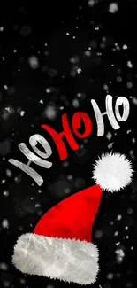 Santa hat with 'Ho Ho Ho' on snowy black background.