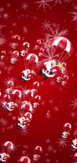 Santa parachuting on a red festive background with snowflakes.