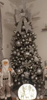 Festive silver Christmas tree with Santa and nutcracker decorations.