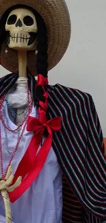 Festive skeleton in traditional outfit with colorful sombrero.