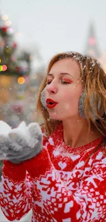 Woman in red sweater enjoying snowfall.