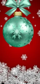 Holiday wallpaper with teal ornament and snowflakes on a red background.