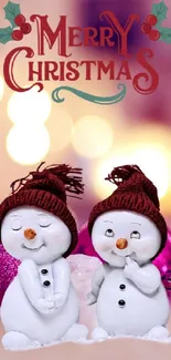 Cute snowmen with Merry Christmas and bokeh lights in the background.