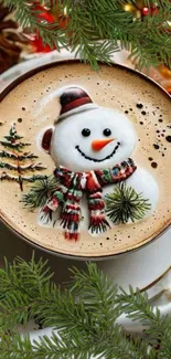 Festive snowman coffee art with Christmas greenery.