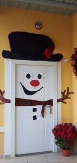 Snowman door decoration with a festive wreath and colorful accents.