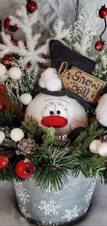 Festive snowman with red berries and green pine in holiday floral display.