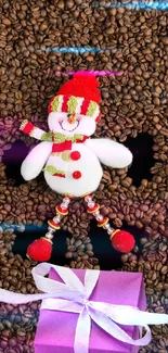 Snowman lying on coffee beans with a purple gift box.