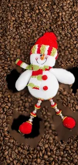 Snowman lying on roasted coffee beans background.