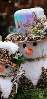 Two festive snowman figures with pine decorations on a winter background.