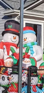 Vibrant yard snowman decorations for holidays.