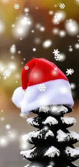 Snow-covered pinecone with Santa hat on festive background.