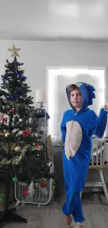 Child in Sonic costume beside decorated Christmas tree.