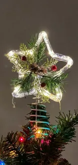 Star-shaped Christmas tree topper glowing with festive lights.