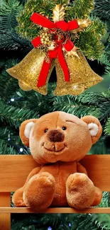 Teddy bear sits under golden bells on a pine-decorated bench.