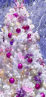 White Christmas tree with pink and purple ornaments in snowy scene.