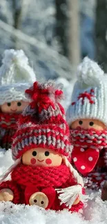 Three cute winter figurines in snow with knitted hats.