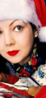 Woman wearing Santa hat with colorful scarf.