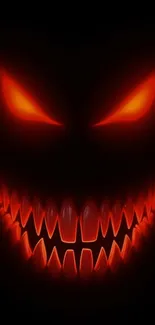 Fiery-eyed monster face with sharp teeth.