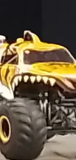 Fierce yellow monster truck with sharp teeth design.