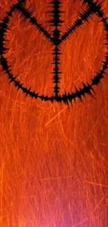 Fiery abstract peace symbol on an orange background.